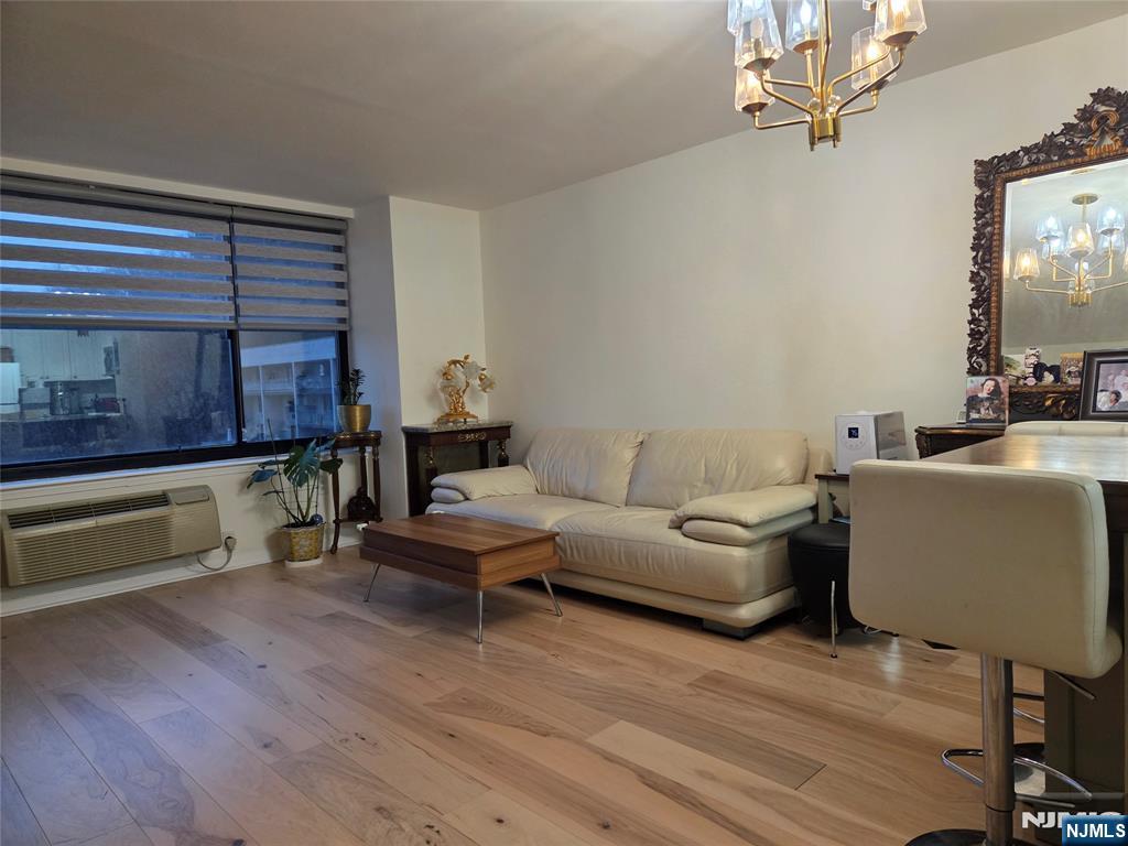 100 Old Palisade Road, Unit 803 Fort Lee, NJ 07024 - Photo 8 of 16 a living room with furniture and wooden floor