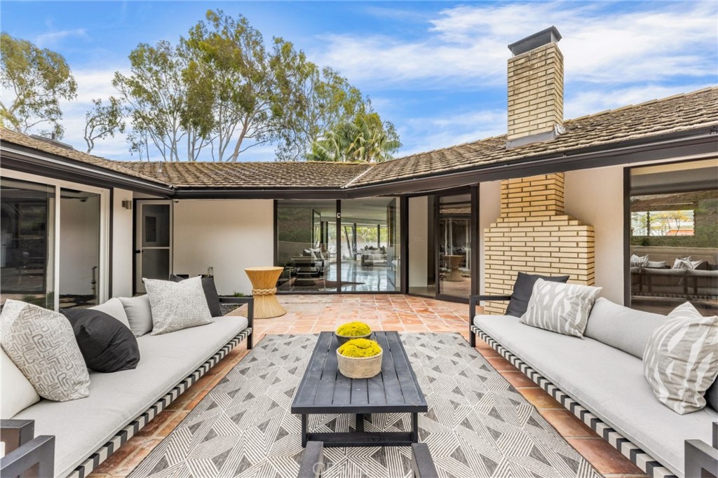 Palos Verdes Peninsula, 90274 - Photo 20 of 47 a view of a patio with couches chairs and wooden floor