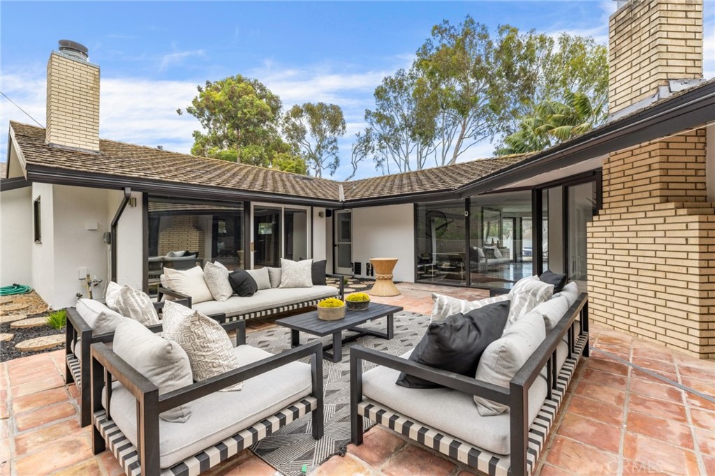 Palos Verdes Peninsula, 90274 - Photo 22 of 47 a view of a house with couches chairs and wooden floor