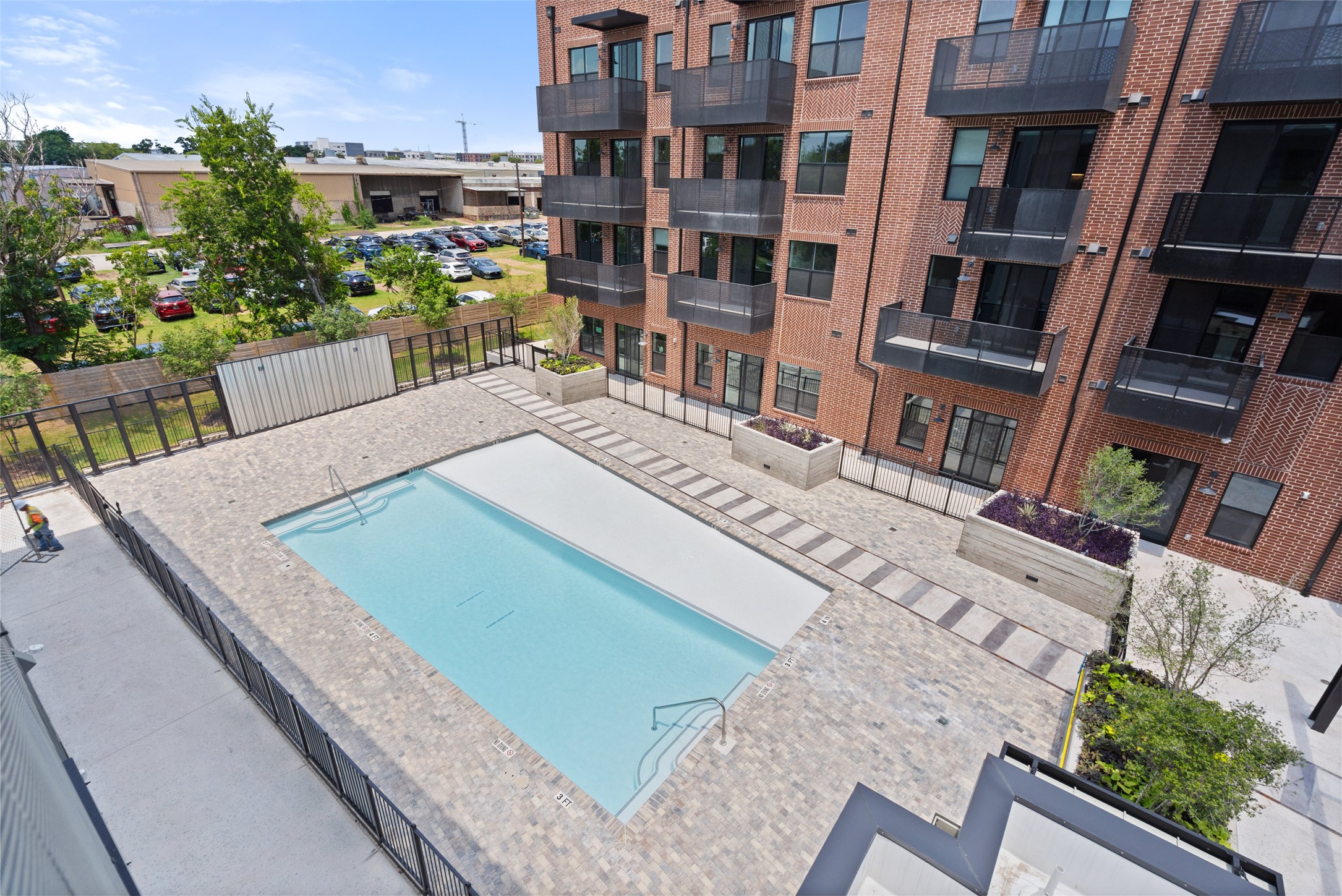 4510 Terry-O Lane, Unit 341 Austin, TX 78745 - Photo 40 of 40 The property features a brick exterior, balconies with dark railings, and large windows