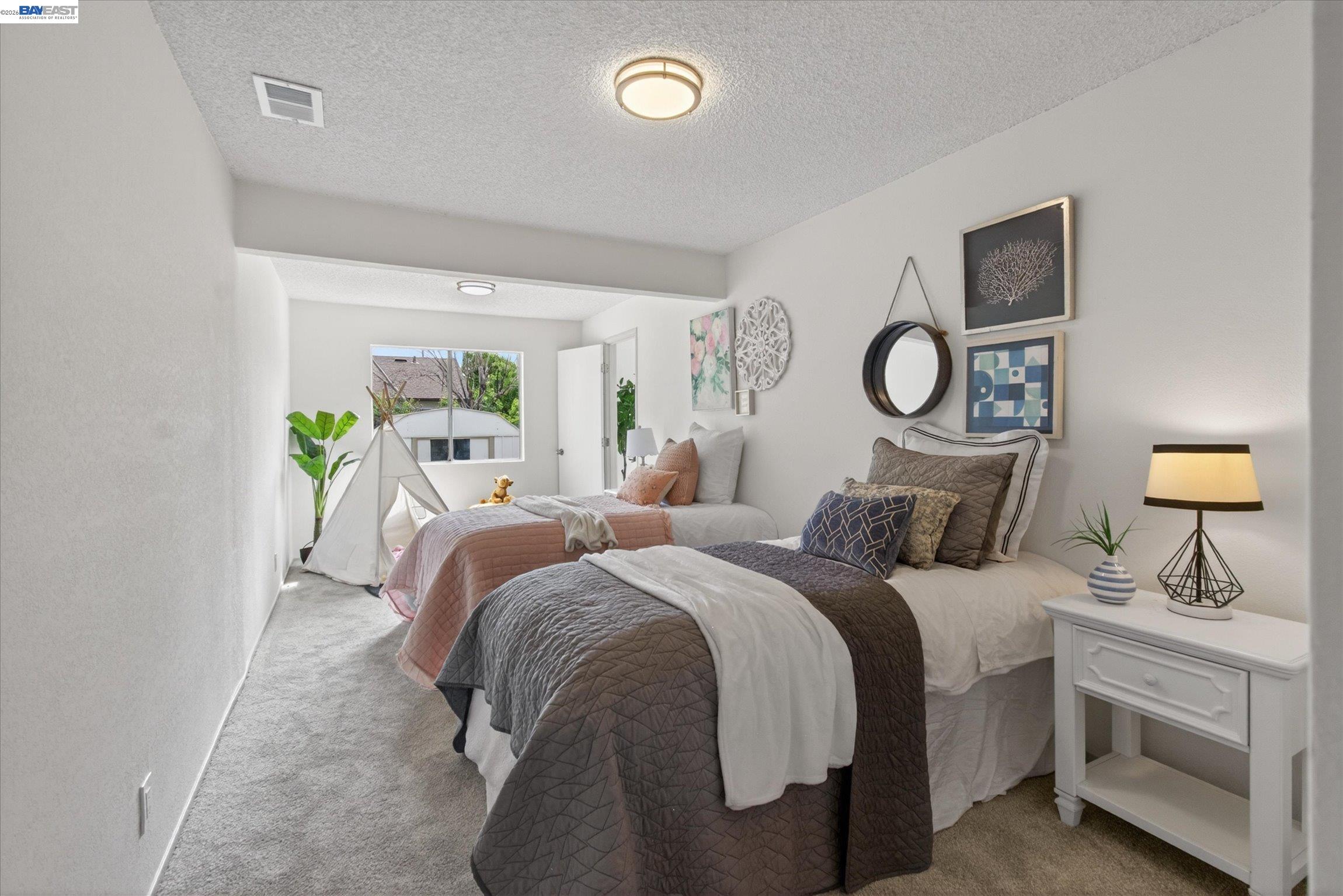 910 Miller Avenue Vallejo, CA 94591 - Photo 19 of 27 a bedroom with a bed and a chandelier