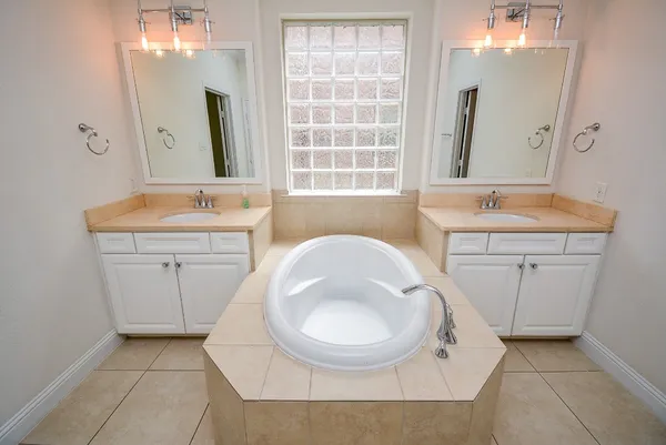 a view of a big room with a ceiling fan and a bathroom