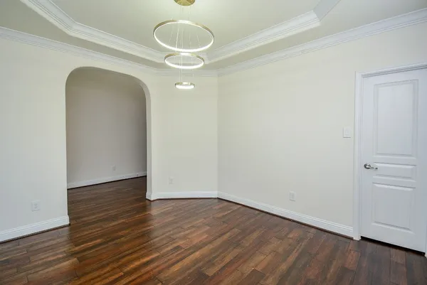 a large living room with a fireplace and wooden floor