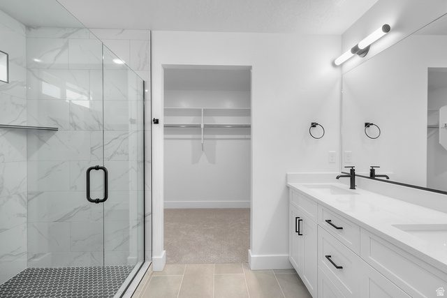 1213 West 500 South Logan, UT 84321 - Photo 13 of 29 Modern bathroom featuring a frameless glass shower enclosure with marble-look tile walls and a mosaic tile floor