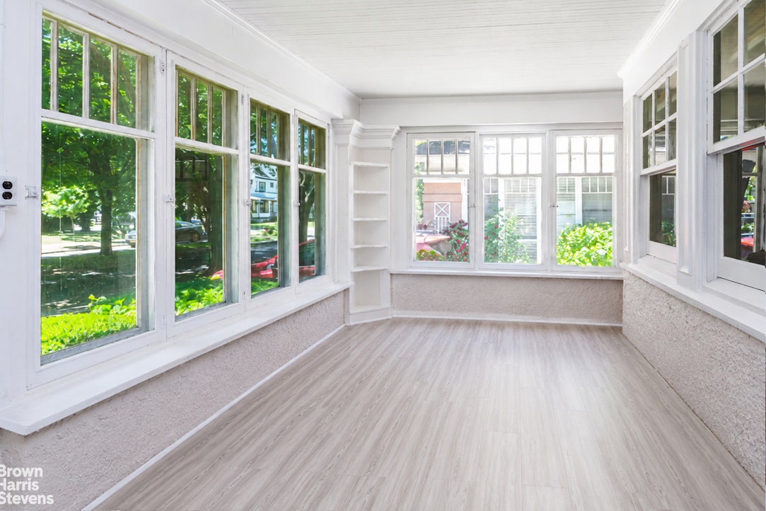 1917 Glenwood Road Brooklyn, NY 11230 - Photo 7 of 22 a view of an empty room with wooden floor and a window