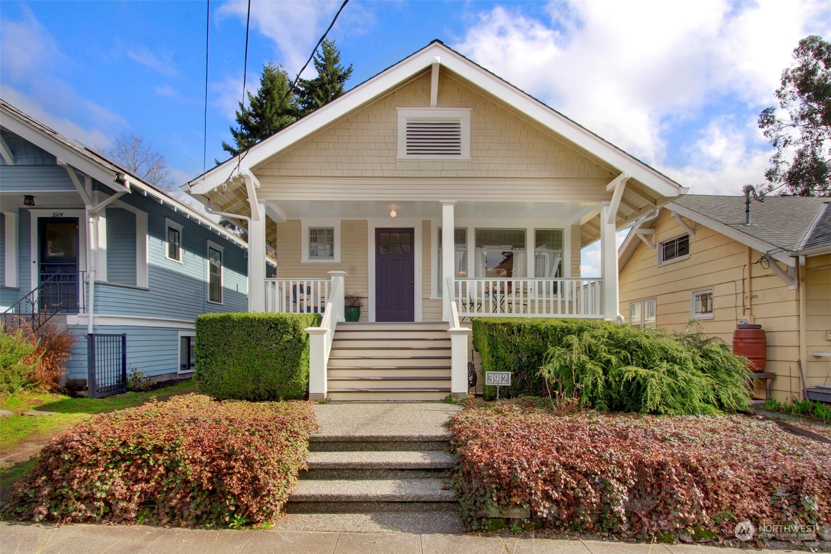 3912 Burke Avenue North Seattle, WA 98103 - Photo 1 of 39 a view of a white house with a small yard plants and large tree