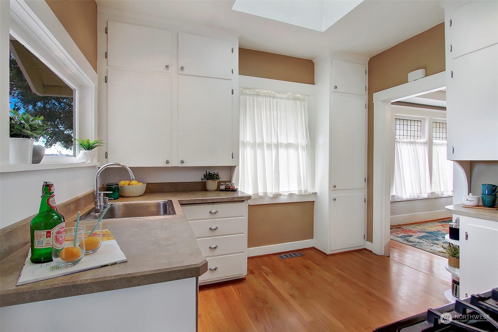 3912 Burke Avenue North Seattle, WA 98103 - Photo 15 of 39 a kitchen with granite countertop a sink stove and cabinets