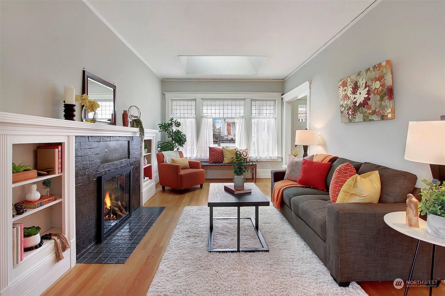 3912 Burke Avenue North Seattle, WA 98103 - Photo 5 of 39 a living room with furniture large window and a fireplace