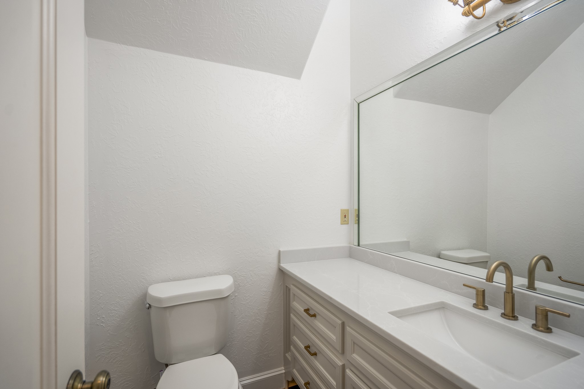15 Lochbury Court Spring, TX 77379 - Photo 18 of 48 The guest half bath downstairs is light and bright and offers beautifully updated countertops and vanity as well as a large mirror to reflect the light.