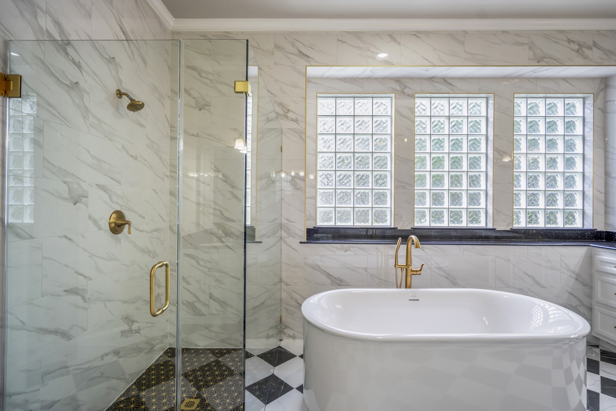 15 Lochbury Court Spring, TX 77379 - Photo 23 of 48 The large glass block window floods the room with soft, natural light while ensuring complete privacy—the best of both worlds for a primary bath.