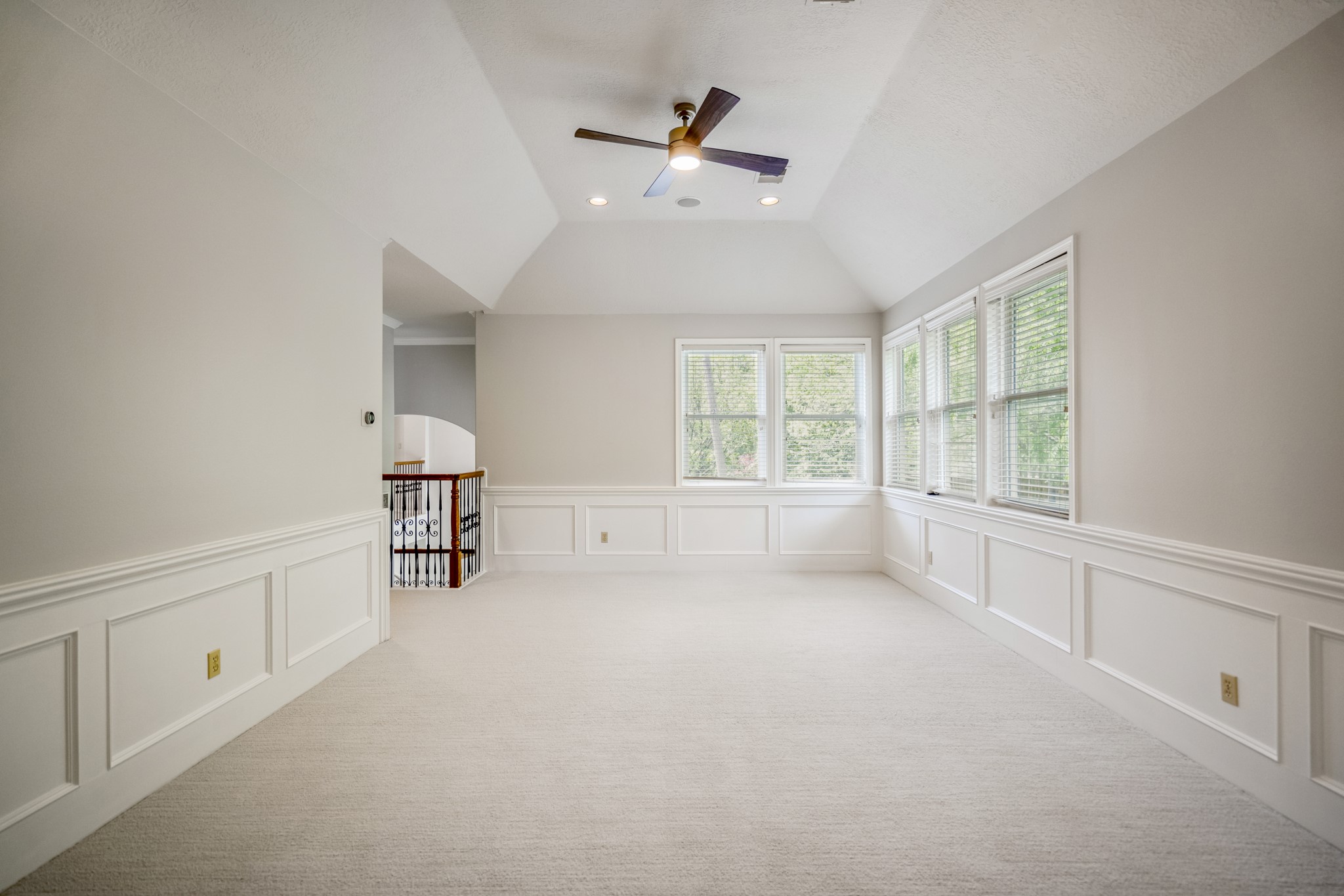 15 Lochbury Court Spring, TX 77379 - Photo 26 of 48 The deep tray/vaulted ceiling adds architectural drama and the wainscoting molding that wraps around the entire room elevates it beyond a standard game room or playroom.