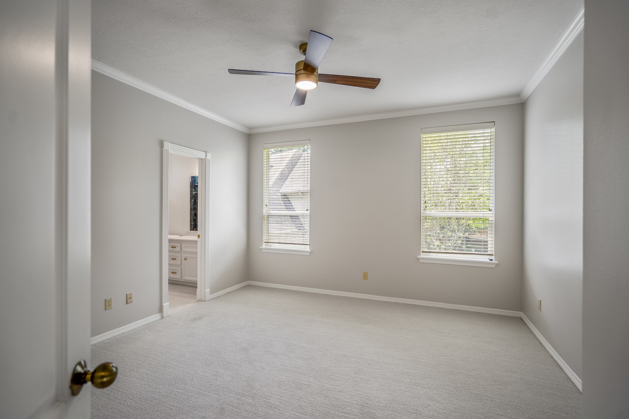 15 Lochbury Court Spring, TX 77379 - Photo 27 of 48 The second bedroom upstairs features neutral tones, crown moldings, dual windows, updated ceiling fan, and easy access to the bathroom which has also been updated.