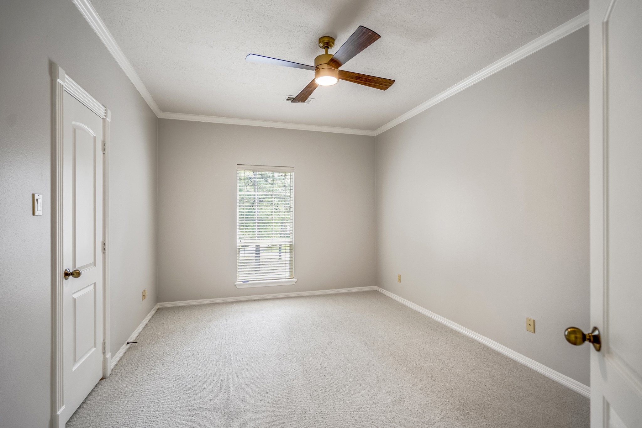 15 Lochbury Court Spring, TX 77379 - Photo 29 of 48 The third bedroom is spacious and offers neutral tones, crown molding, updated ceiling fan, lots of natural light and nice size closet.