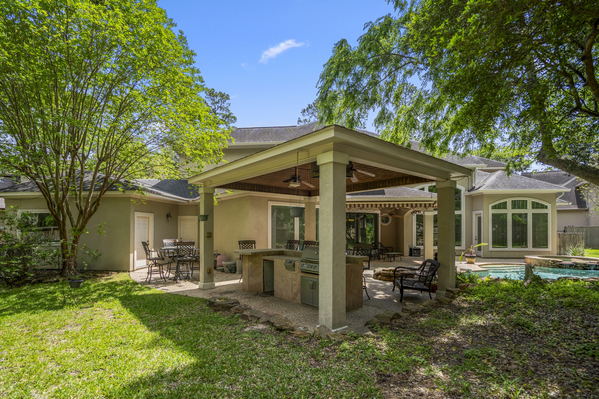 15 Lochbury Court Spring, TX 77379 - Photo 35 of 48 Spend summertime outdoors in the fresh air under the pavillion with summer kitchen where you can host your parties where there is space for all to spread out and enjoy themselves.