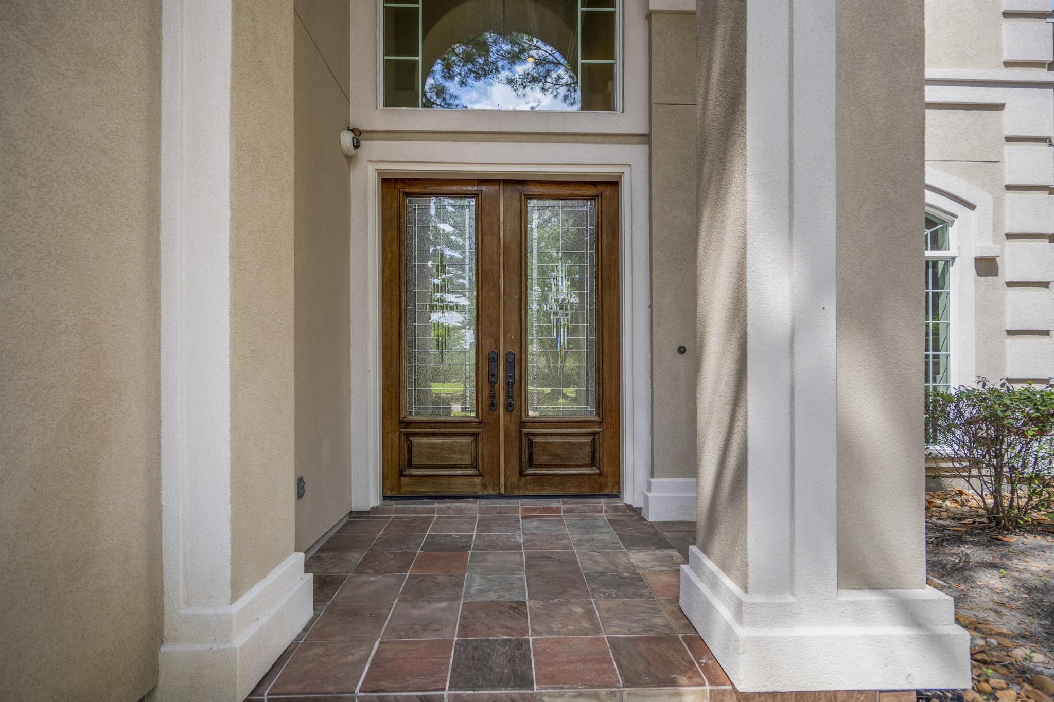 15 Lochbury Court Spring, TX 77379 - Photo 4 of 48 This entryway makes an iviting first impression by blending classic architectural details with warm, multi-tonal slate tile underfoot for a sophisticated, earthy texture that complements the neutral exterior palette.