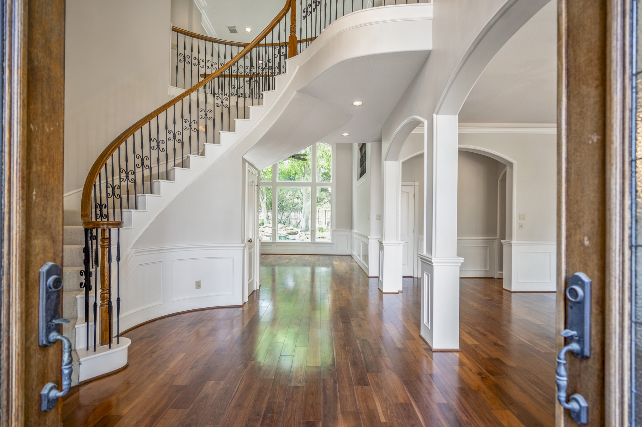 15 Lochbury Court Spring, TX 77379 - Photo 5 of 48 Offering a grand entry, as you enter the home you have a sculptural staircase, rich gleaming wood flooring and stunning views of the backyard oasis.