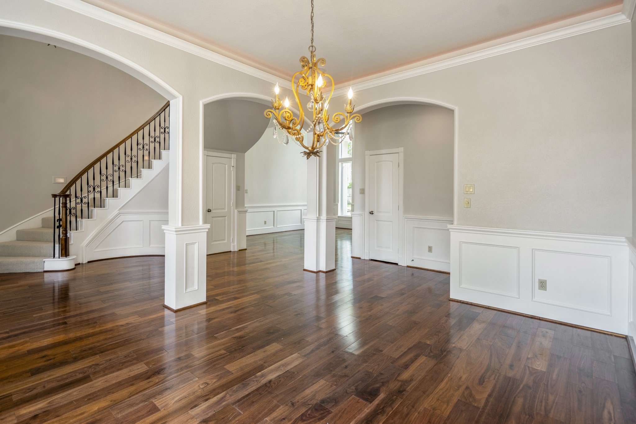 15 Lochbury Court Spring, TX 77379 - Photo 7 of 48 The elegant dining room features warm tones of the hardwood flooring that flow seamlessly throughout the main level, complemented by classic wainscoting and deep crown molding.