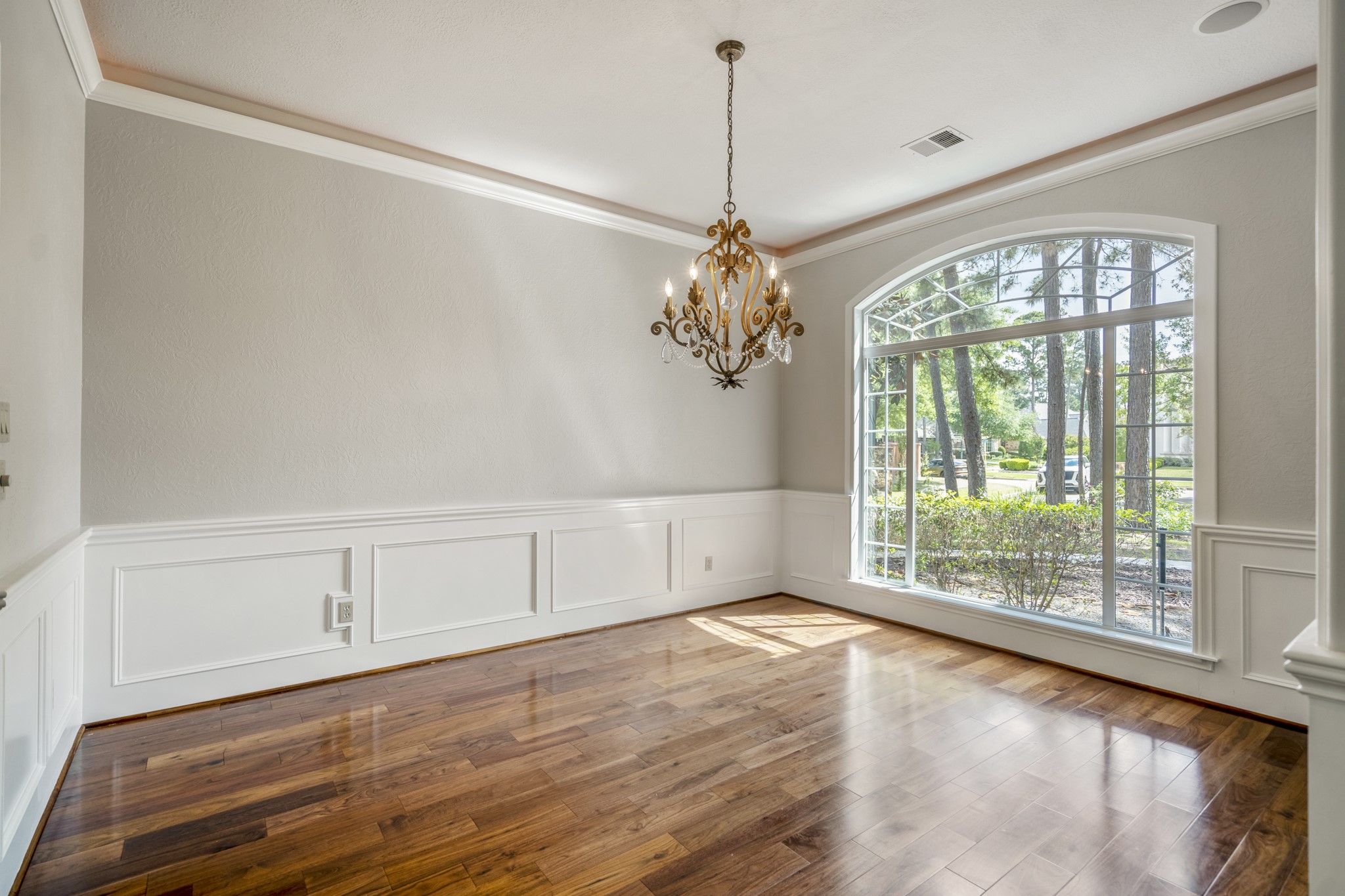 15 Lochbury Court Spring, TX 77379 - Photo 8 of 48 The dining room provides a sophisticated and airy room at the front of the home with the large window, neutral tones and same rich wood flooring.