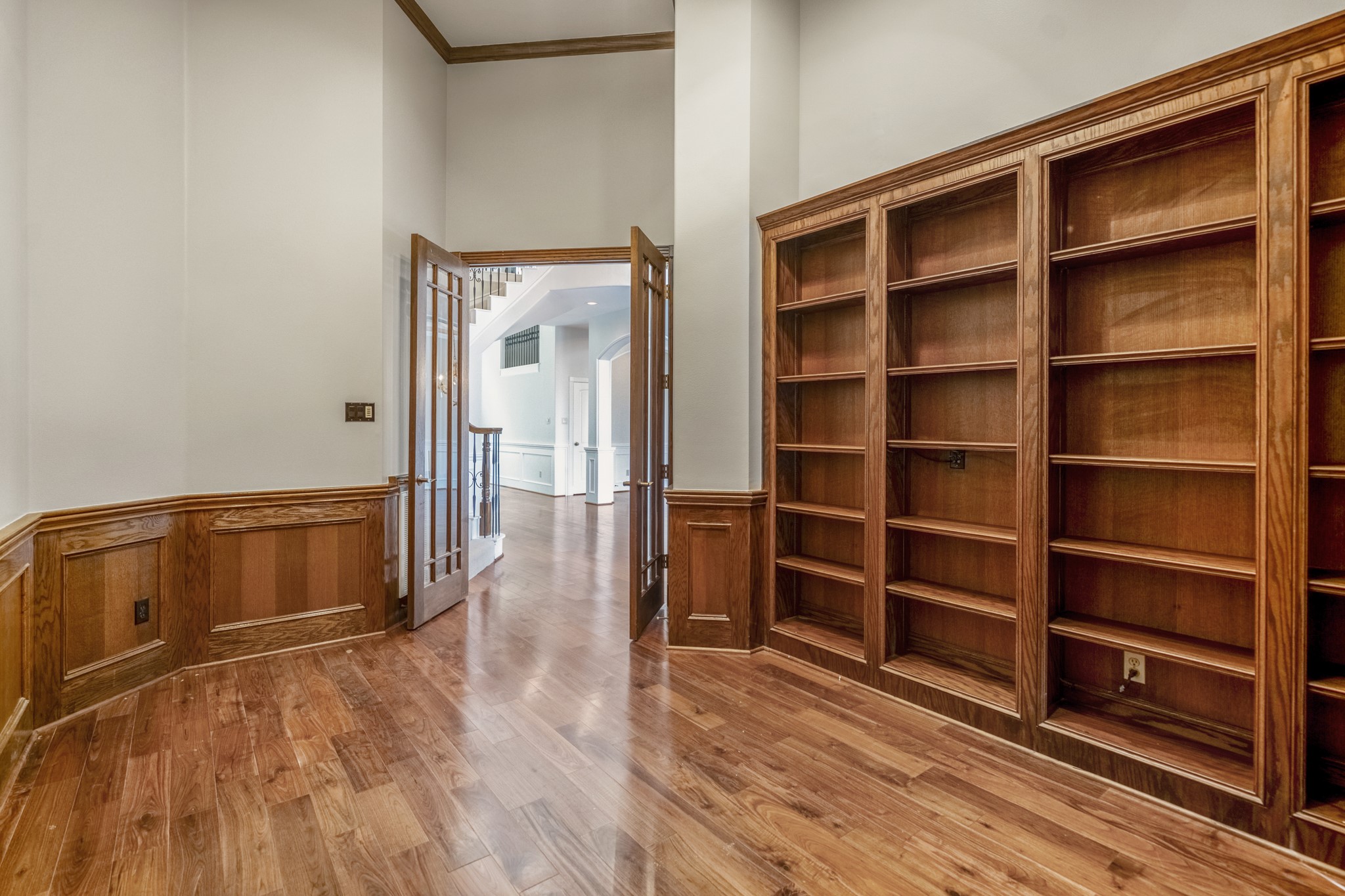 15 Lochbury Court Spring, TX 77379 - Photo 10 of 48 The focal point of the large study is the floor-to-ceiling rich-toned shelving. It offers an incredible amount of space for a curated book or art collection, awards, or high-end decor.