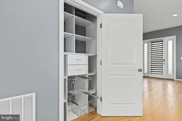 a view of storage and utility room with wooden floor