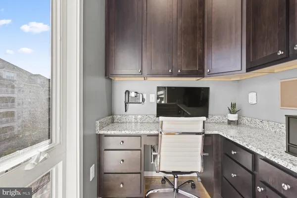 a kitchen with granite countertop cabinets stainless steel appliances and a sink