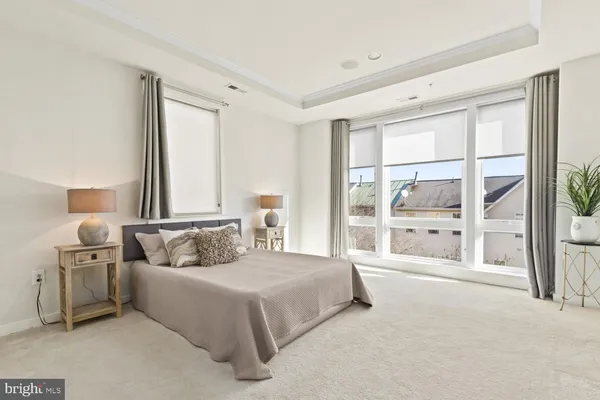 a spacious bedroom with a large bed and a large window