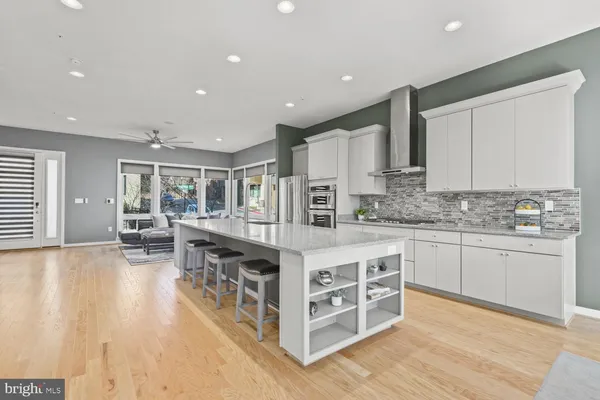 a kitchen with stainless steel appliances granite countertop a stove and a white cabinets