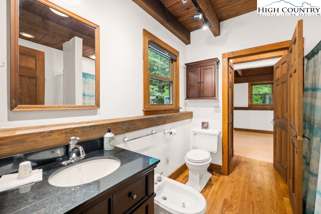 737 Tennant Road Newland, NC 28657 - Photo 20 of 38 a bathroom with a granite countertop toilet sink and mirror