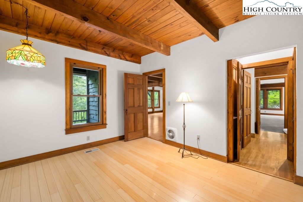 737 Tennant Road Newland, NC 28657 - Photo 23 of 38 a view of an empty room with window and wooden floor