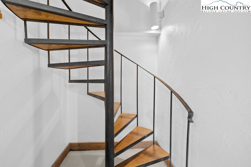 737 Tennant Road Newland, NC 28657 - Photo 30 of 38 a view of staircase with wooden floor and a window