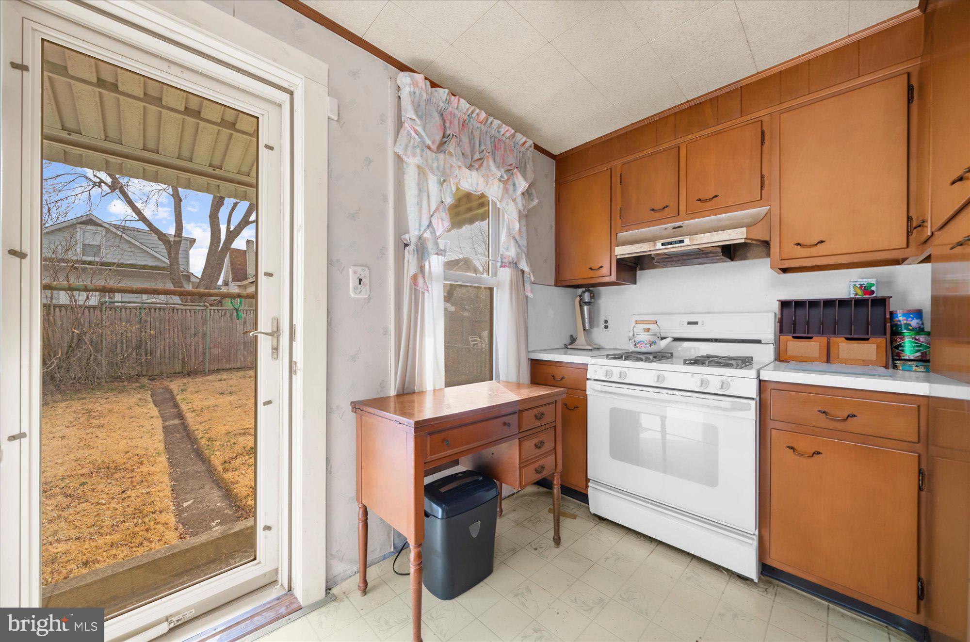 108 Fitzrandolph Avenue Hamilton, NJ 08610 - Photo 12 of 30 a kitchen with stainless steel appliances granite countertop a refrigerator a stove and a sink with cabinets