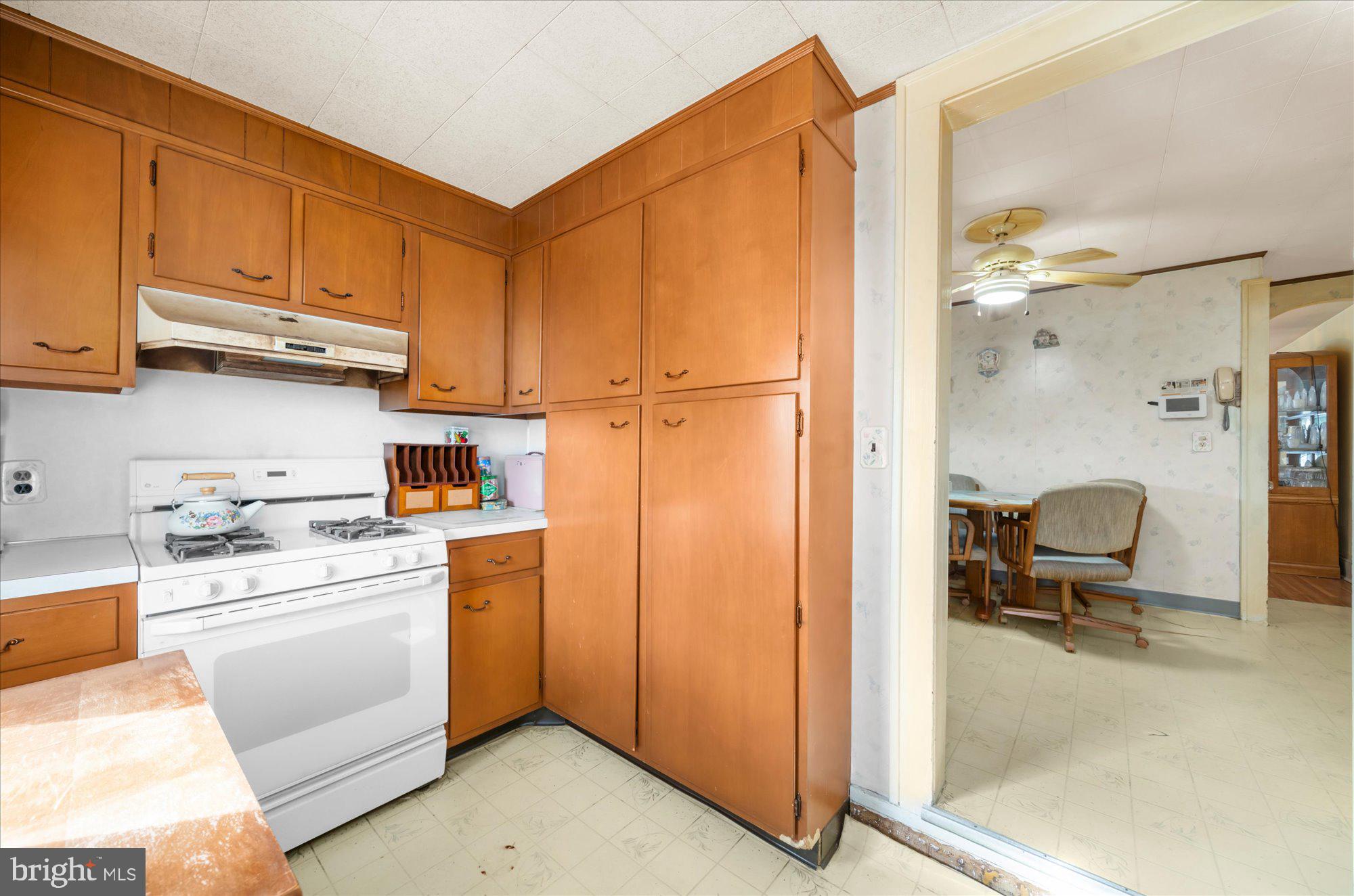 108 Fitzrandolph Avenue Hamilton, NJ 08610 - Photo 13 of 30 a kitchen with a refrigerator a stove a washer and dryer