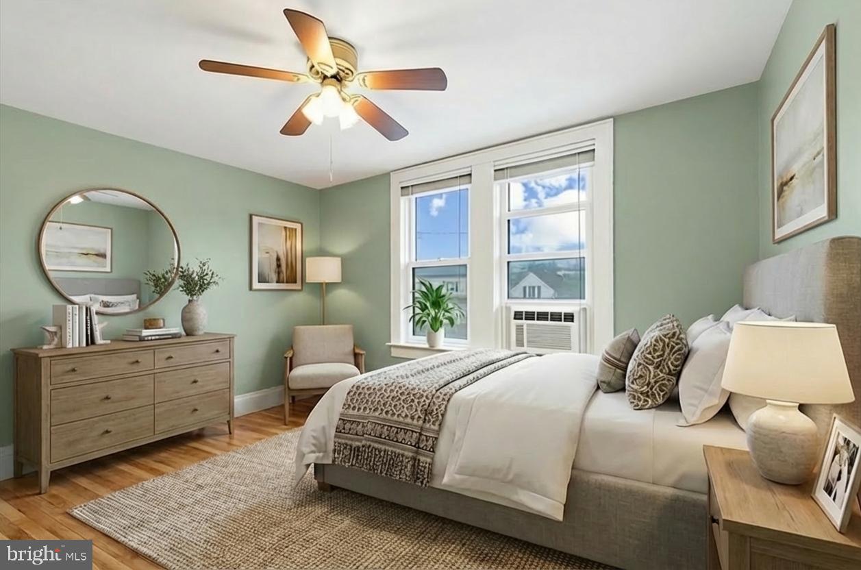 108 Fitzrandolph Avenue Hamilton, NJ 08610 - Photo 21 of 30 a bedroom with a large bed and a chandelier