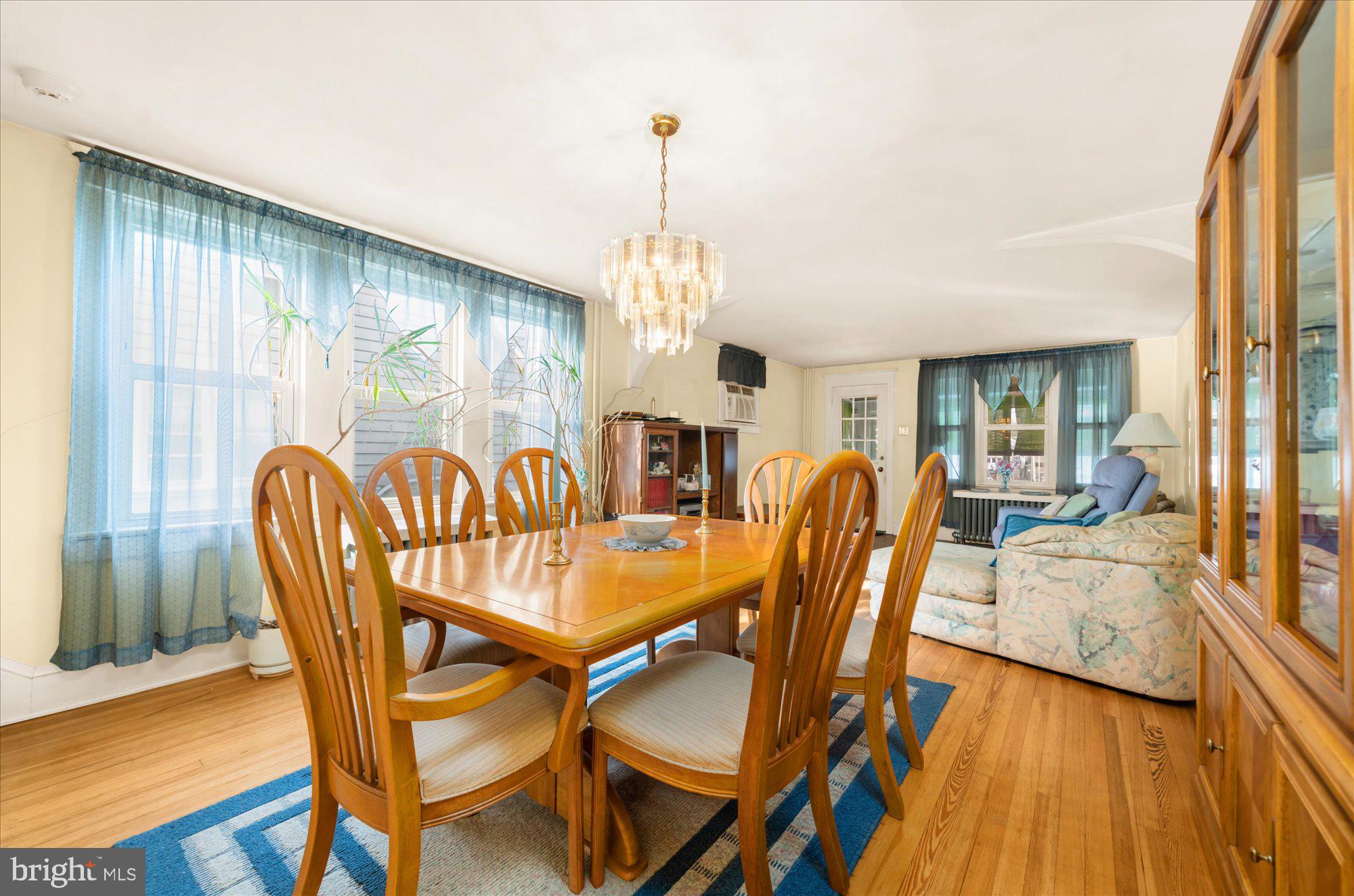 108 Fitzrandolph Avenue Hamilton, NJ 08610 - Photo 7 of 30 a dining room with furniture a chandelier and wooden floor