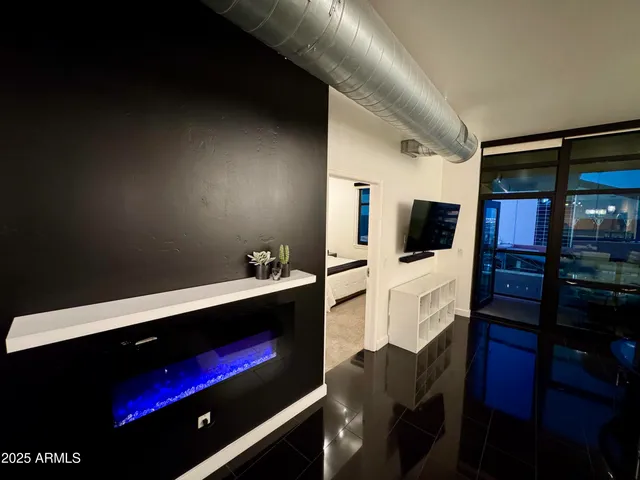 a table with chairs and a wooden floor in a room