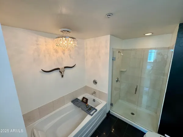 a bedroom with a bed and a painting on the wall