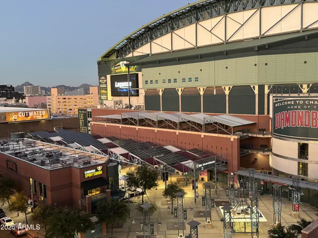 a view of a bedroom with furniture and wooden floor