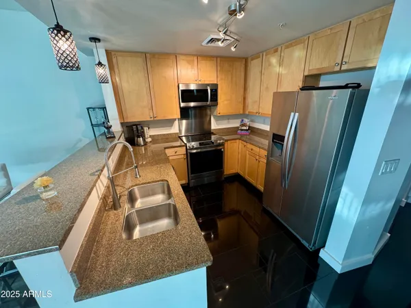 a kitchen with sink refrigerator and microwave