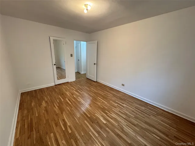 a view of an empty room and wooden floor