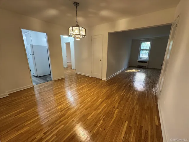 a view of a room with wooden floor staircase and a kitchen