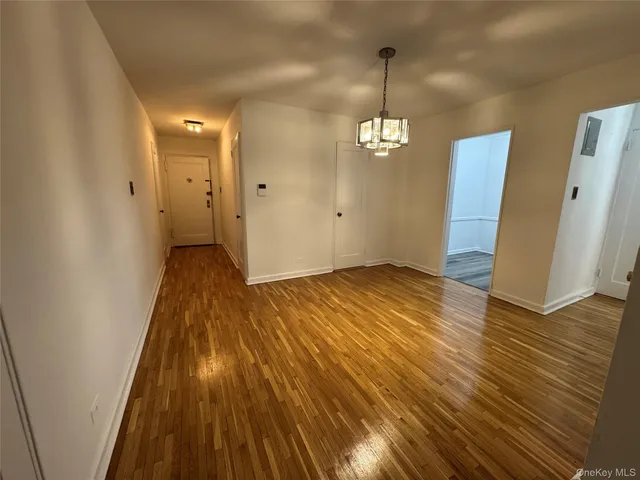 a view of a room with wooden floor and staircase