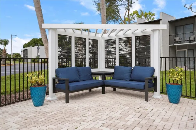 a view of a patio with a chairs and a potted plant