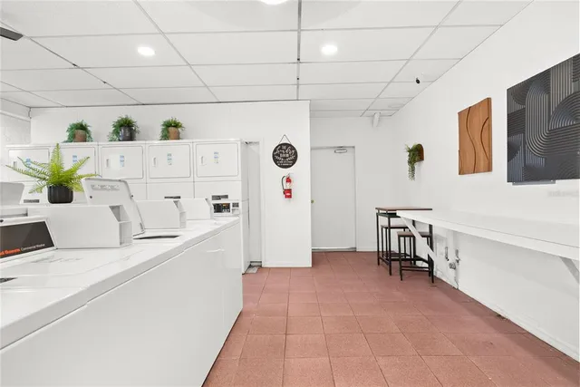 a kitchen with stainless steel appliances kitchen island granite countertop a refrigerator and a sink