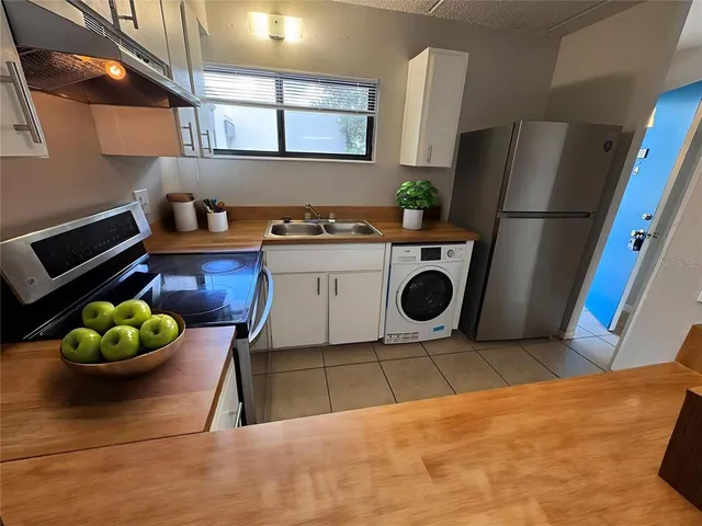a kitchen with a refrigerator and a stove