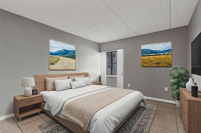 a bedroom with a bed and painting on the wall