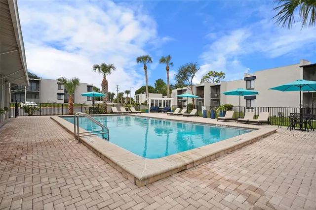 a view of a swimming pool with a lounge chairs