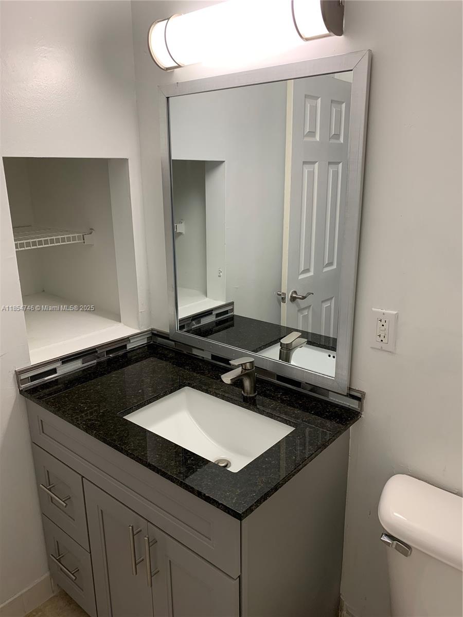 Royal Poinciana Condominium Pompano Beach, FL 33069 - Photo 3 of 6 a bathroom with a sink and a toilet