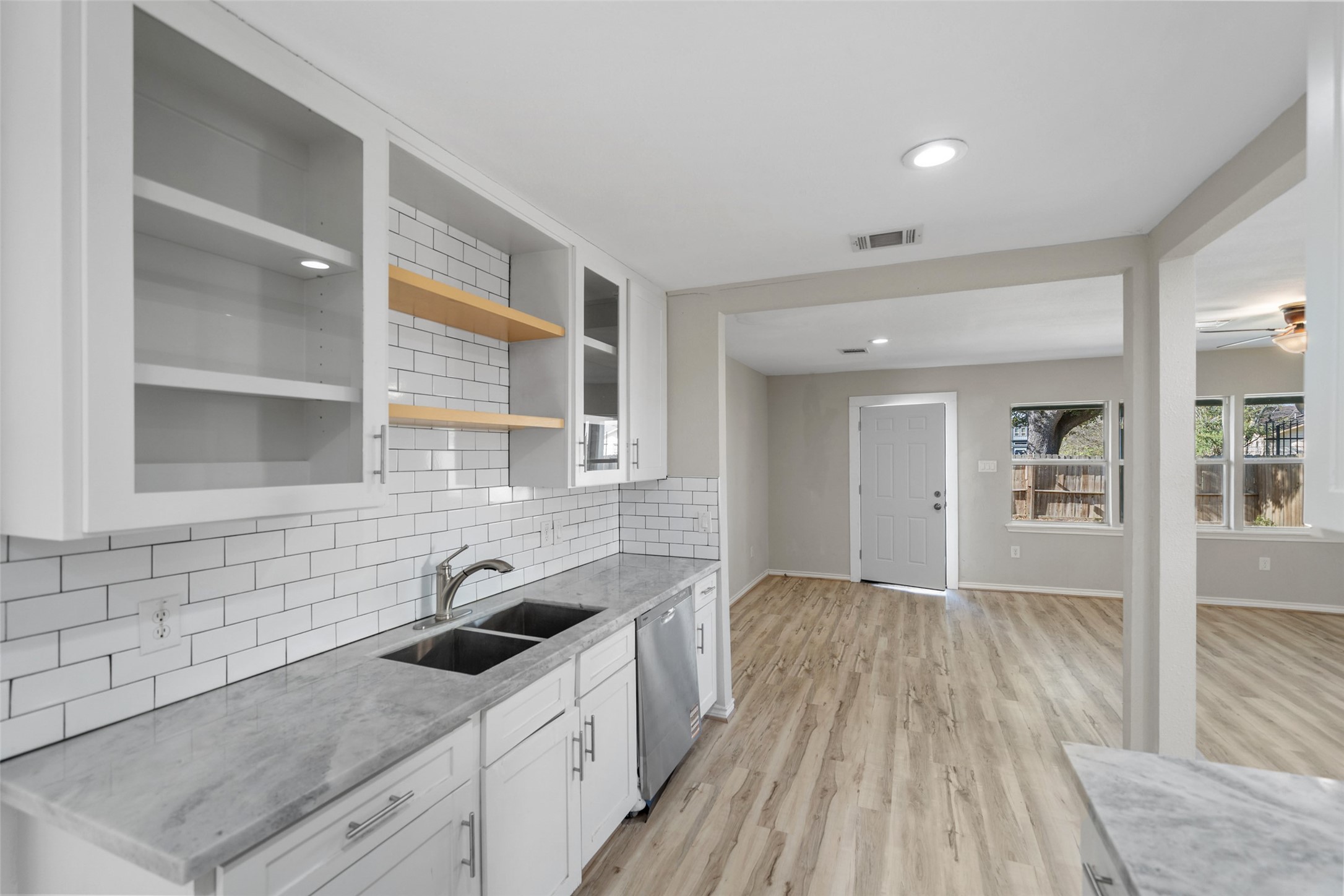 7019 Sur Court Houston, TX 77033 - Photo 11 of 22 a kitchen with granite countertop a sink cabinets and wooden floor