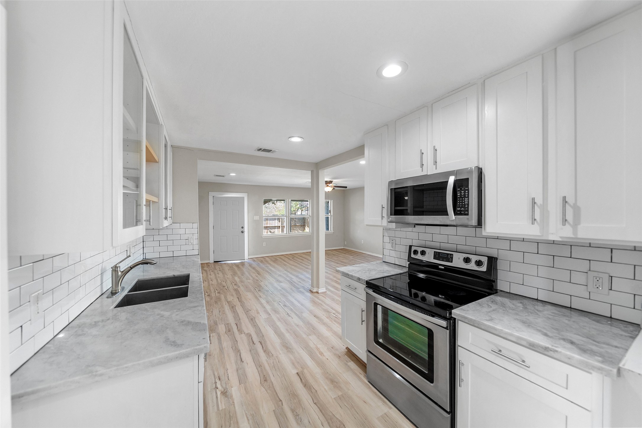 7019 Sur Court Houston, TX 77033 - Photo 12 of 22 a kitchen with stainless steel appliances granite countertop a stove and a microwave