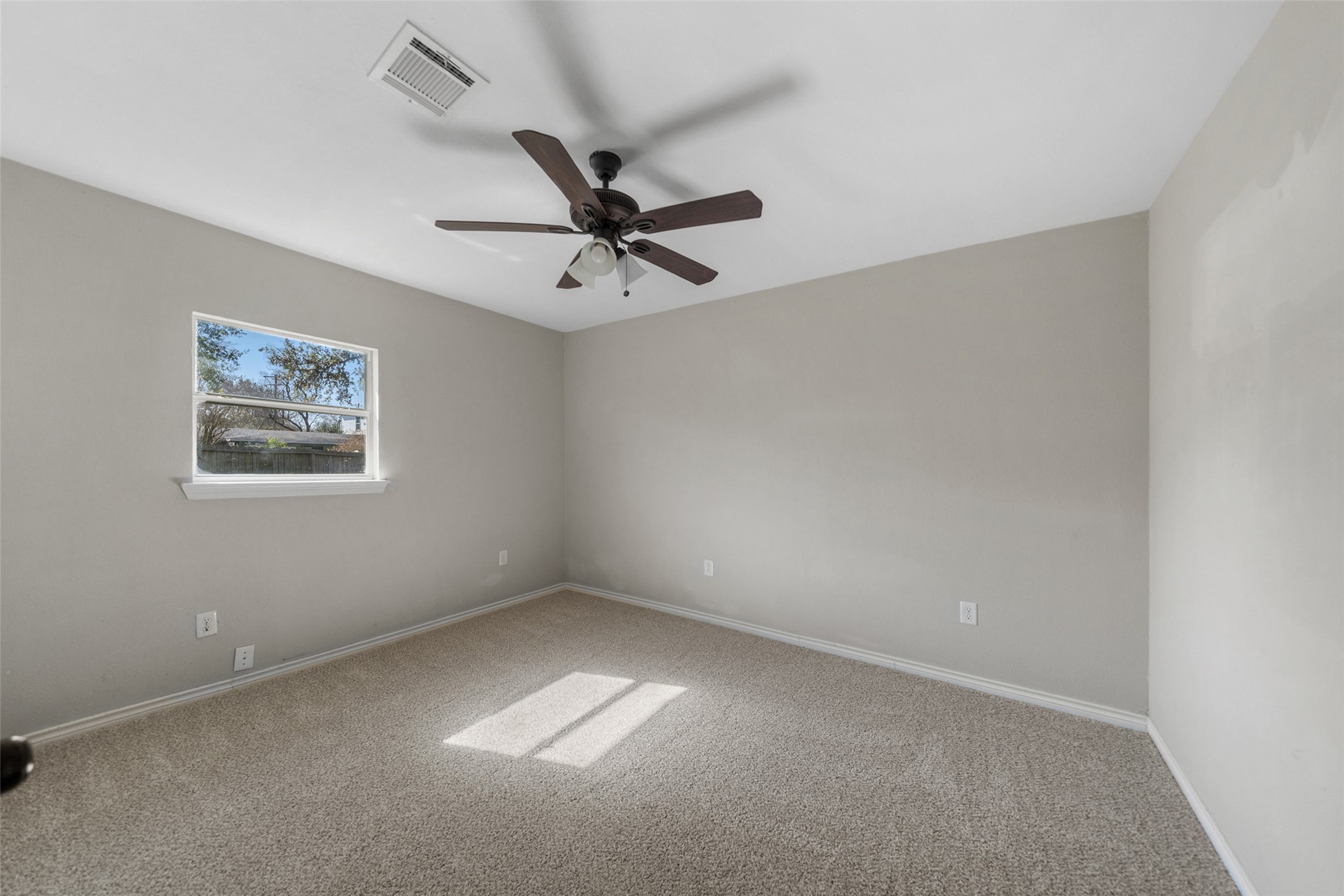 7019 Sur Court Houston, TX 77033 - Photo 13 of 22 an empty room with a window and a fan